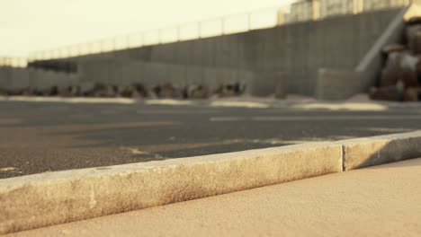 empty urban street scene with curb and wall