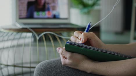 Close-up-video-of-woman-studying-during-a-video-conference