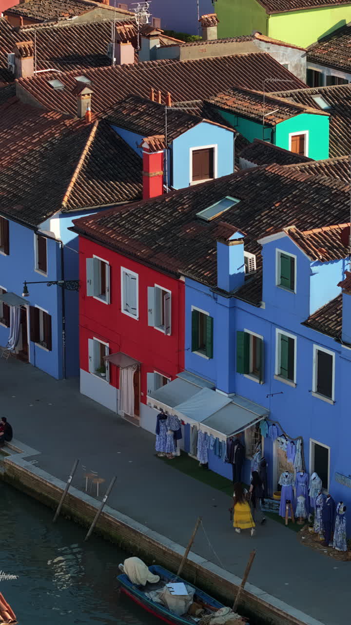 Aerial drone view of the colourful houses of Burano Italy. Vertical