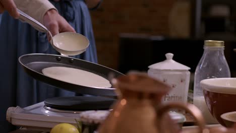 pouring crepe batter into pan