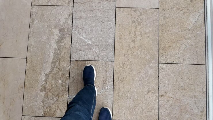 Person walking on a tiled floor
