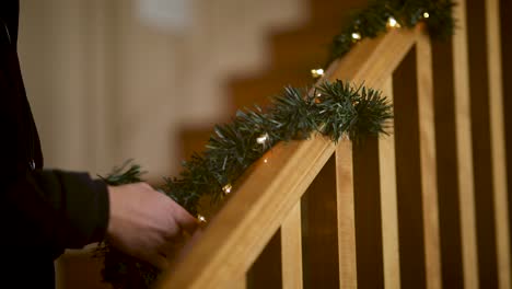 christmas lights - garland on staircase railing banister, closeup