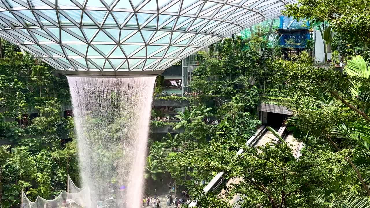Singapore Jewel Indoor Waterfall Vortex at Changi Airport - slow pan left tree canopy