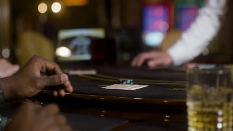 man looking at his hand of cards.