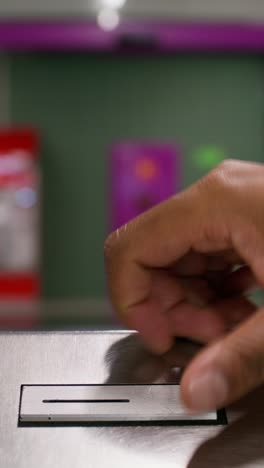 hand donating money into a donation box