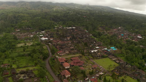 Aerial-view-of-Besakih-Temple-in-Bali,-surrounded-by-rainforest.-Wide-aerial-panoramic-view-of-religious-buildings-and-pagodas-in-Hindu-temple-in-Indonesia