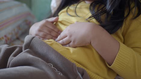 young girl holding her stomach in pain