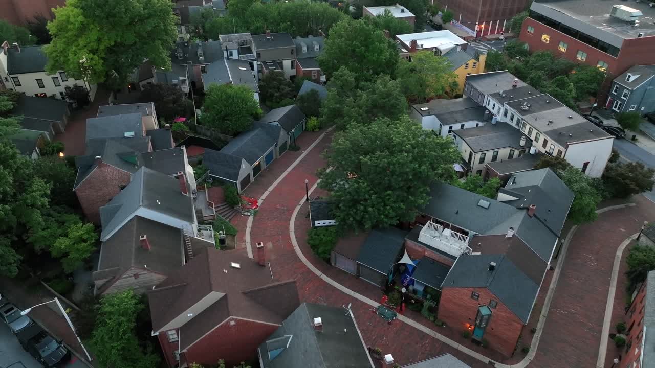 Single Family houses and historic townhouses in American town. Aerial flyover shot. Cloudy summer day with green trees. Aerial top down. Two story homes in quiet suburb of Lancaster, Pennsylvania