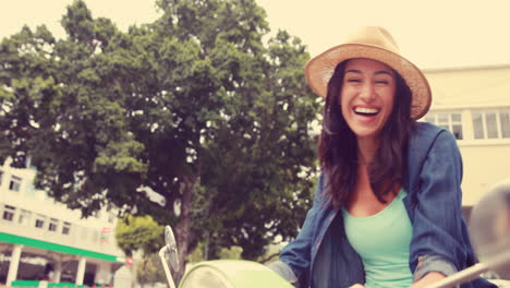 Smiling-woman-sitting-on-a-scooter