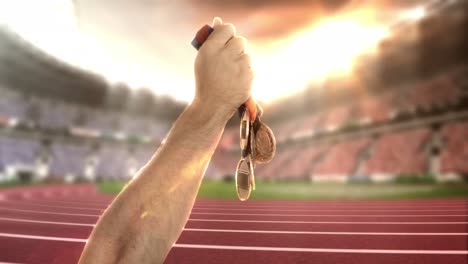 hand of athlete holding gold medals