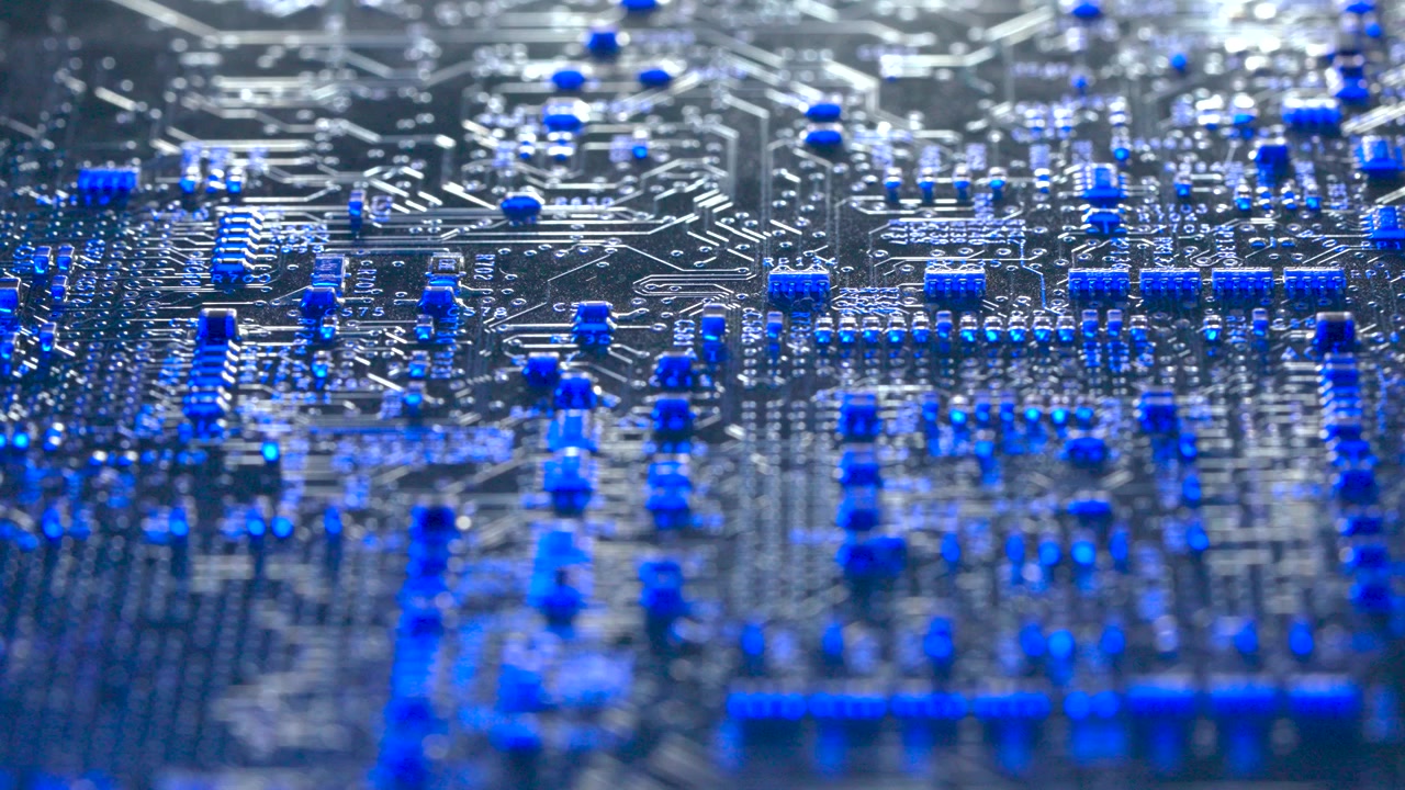 Close up shot of a notebook motherboard with blue cinematic lighting reflecting on microchips and circuits.