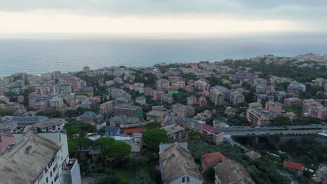 coastal italian town with colorful buildings overlooking the sea on an overcast day, aerial view