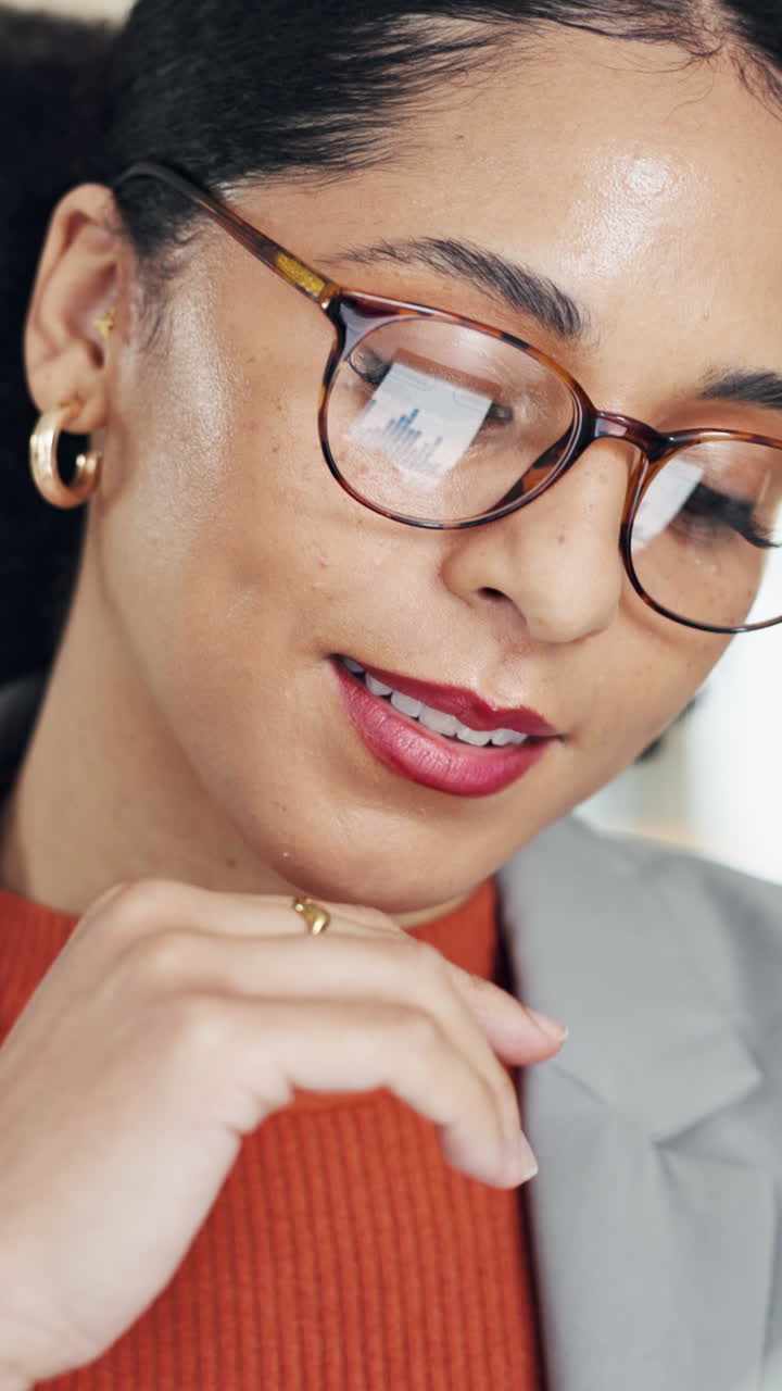 Close-up of a Thoughtful Businesswoman with Data Reflected in Her Glasses