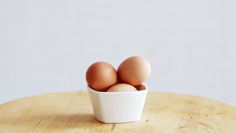 three eggs in white bowl