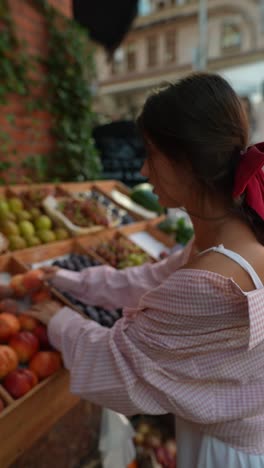 woman shopping at a street fruit market