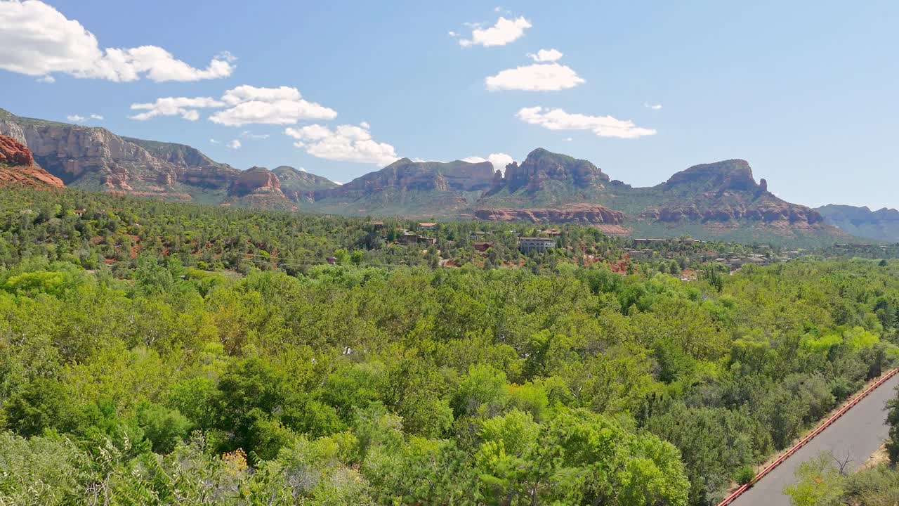 Sedona in Arizona wild reddish sandstone type looking mountains with trees rocks and brush all around