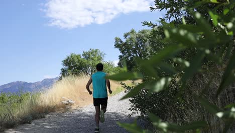 slow motion shot of a active man going trail running on the outdoor mountainous trails of draper city, utah