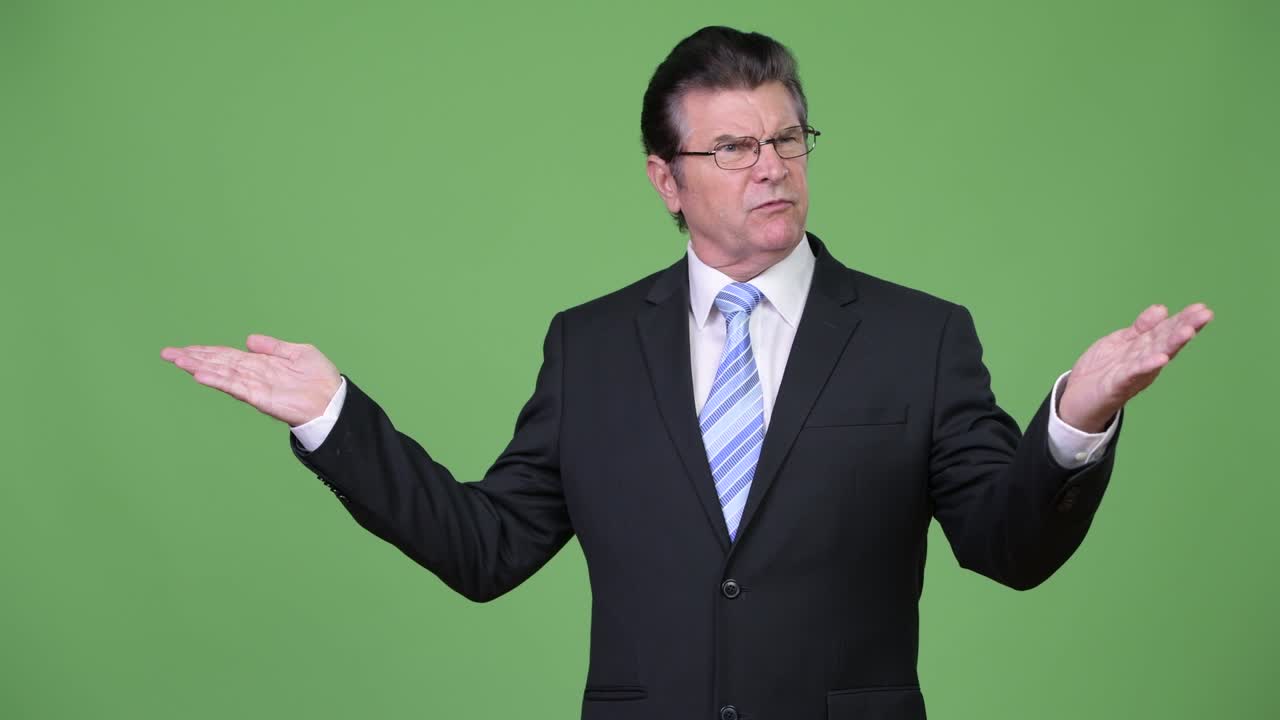 Senior handsome businessman talking