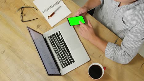 Man-using-smartphone-and-laptop