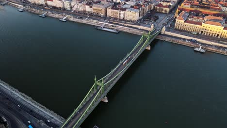 Tram-passing-across-Liberty-bridge-in-Budapest-Hungary-with-Danube-river-view-,4K-aerial-topdown-drone-shot-2