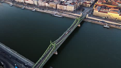 tram passing across liberty bridge in budapest hungary with danube river view ,4k aerial topdown drone shot 2