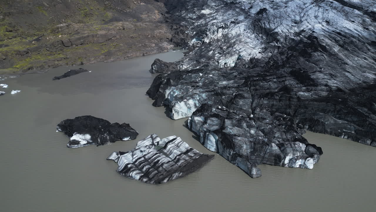 Sólheimajökull Glacier with lake on Iceland island. Aerial top down shot. Cloudy day in highlands of Iceland