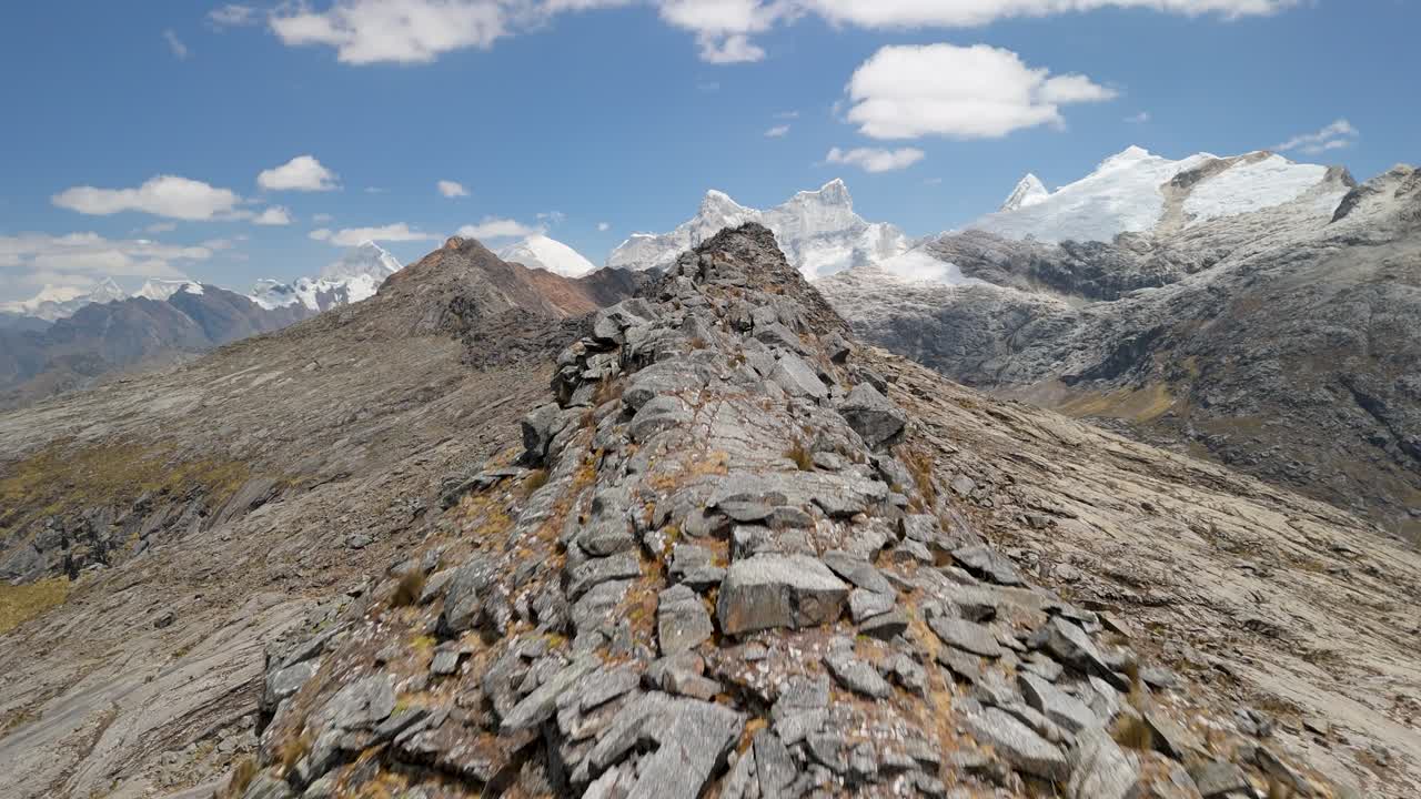 Fast aerial drone shot flying closely over a jagged rocky ridge on the Santa Cruz Trek in the Peruvian Andes
