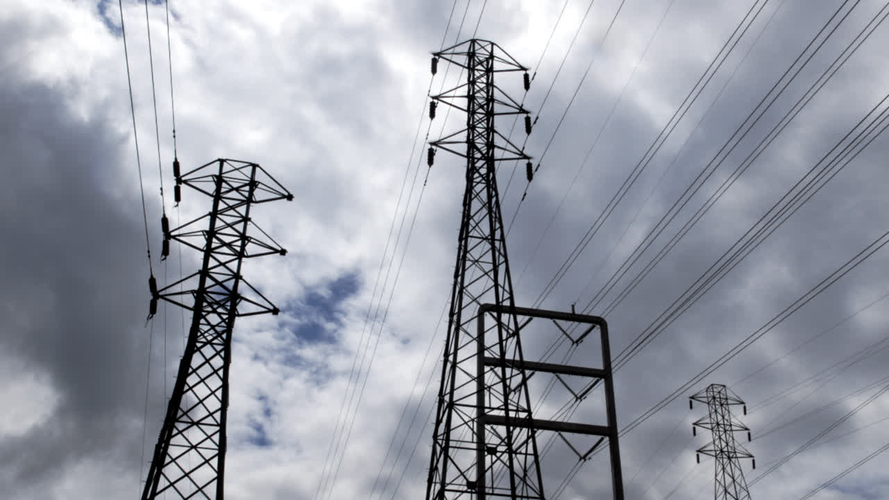 Timelapse of clouds blowing above electrical power lines