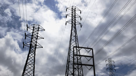 Timelapse-of-clouds-blowing-above-electrical-power-lines