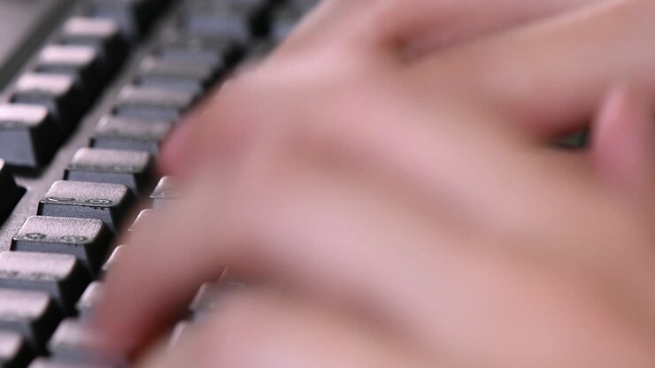 Extreme close-up on the computer keyboard while typing on it