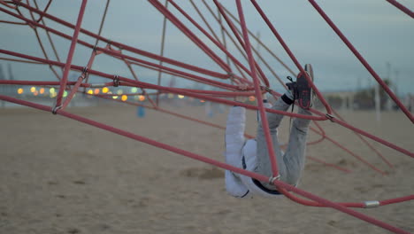 Young-boy-playing-on-the-beach-on-a-cold-day