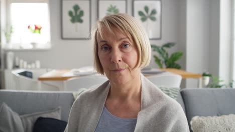 Video-portrait-of-senior-woman-sitting-at-home