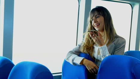 Woman-talking-on-mobile-phone-while-travelling-in-ferry-4k