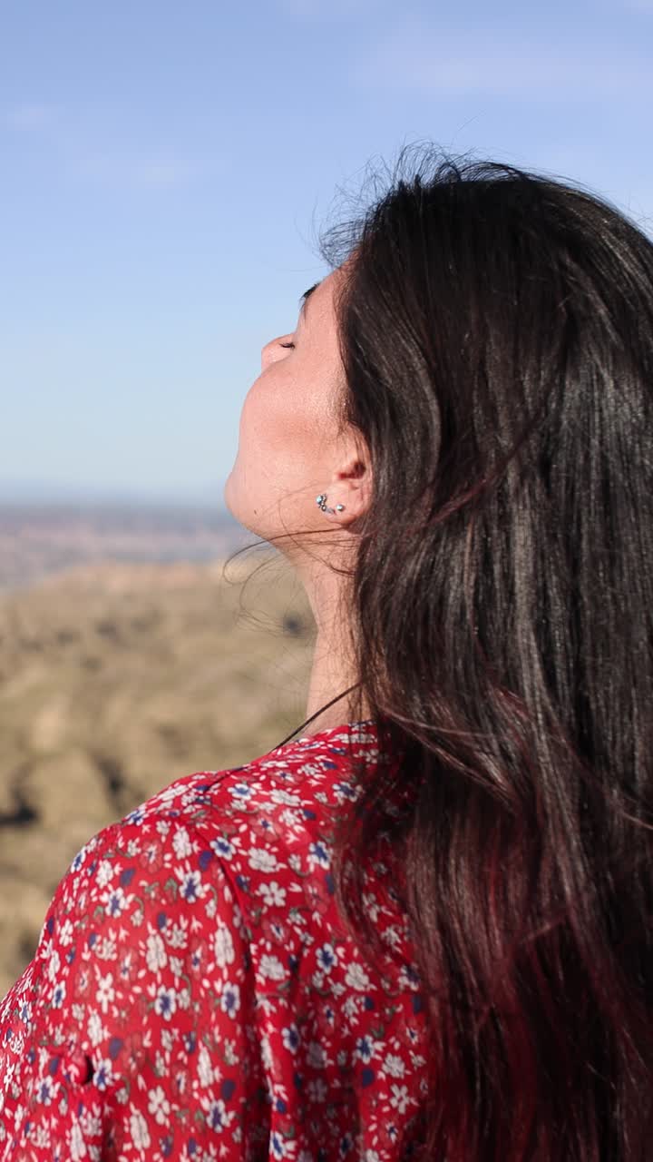 A woman looking up towards the sky outdoors