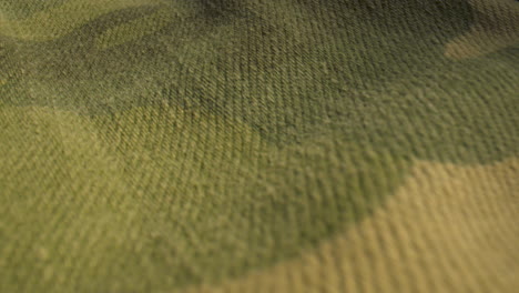 extreme close up slide over camo patterned fabric