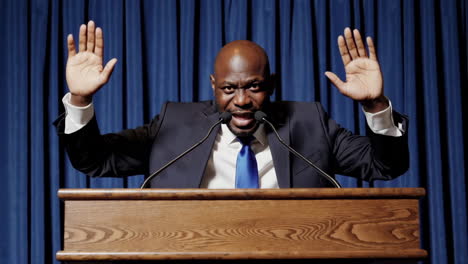 man speaking at a podium