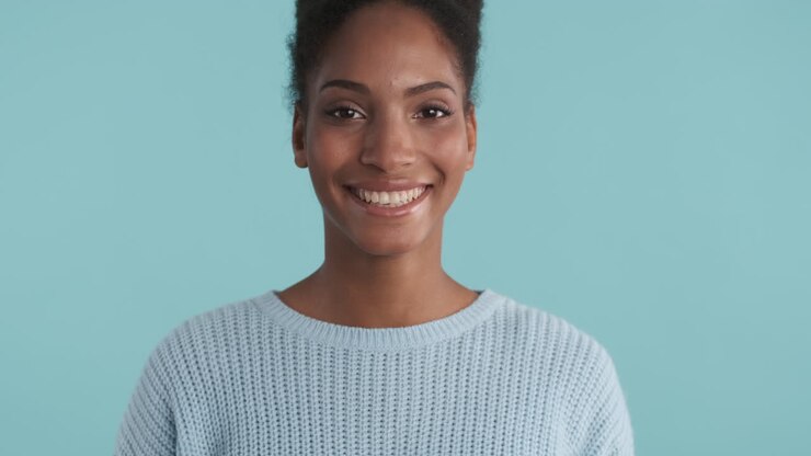 Smiling young woman in blue sweater