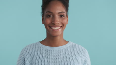 smiling young woman in blue sweater