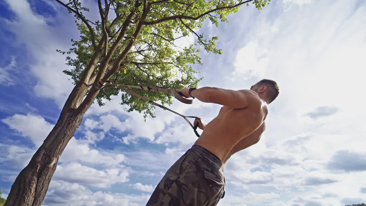 Man exercising in park. Fitness man doing fitness exercises outdoor