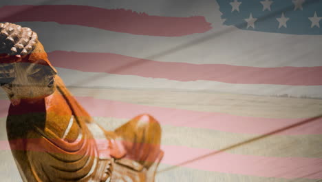 animation of buddha figure moving over american flag