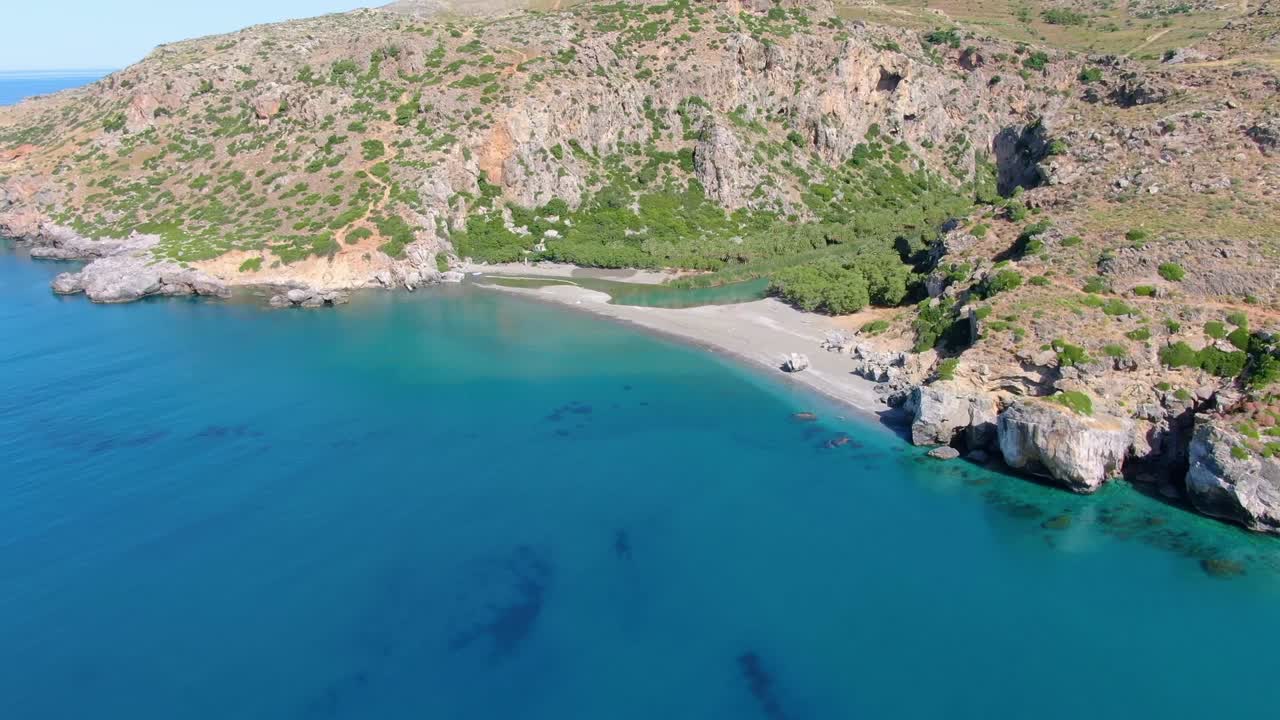 Cinematic aerial shot revealing the mountains around Preveli and mediterranean sea
