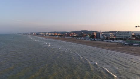 scenic sunset aerial dips low over water of adriatic sea, senigallia, italy