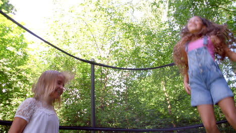 two girls jumping on trampoline shot in slow motion