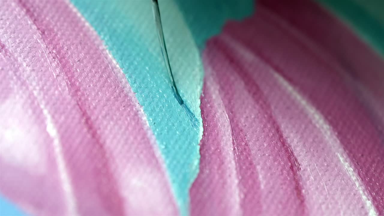 Macro shot of wet pink and blue paint texture with fine brush detail
