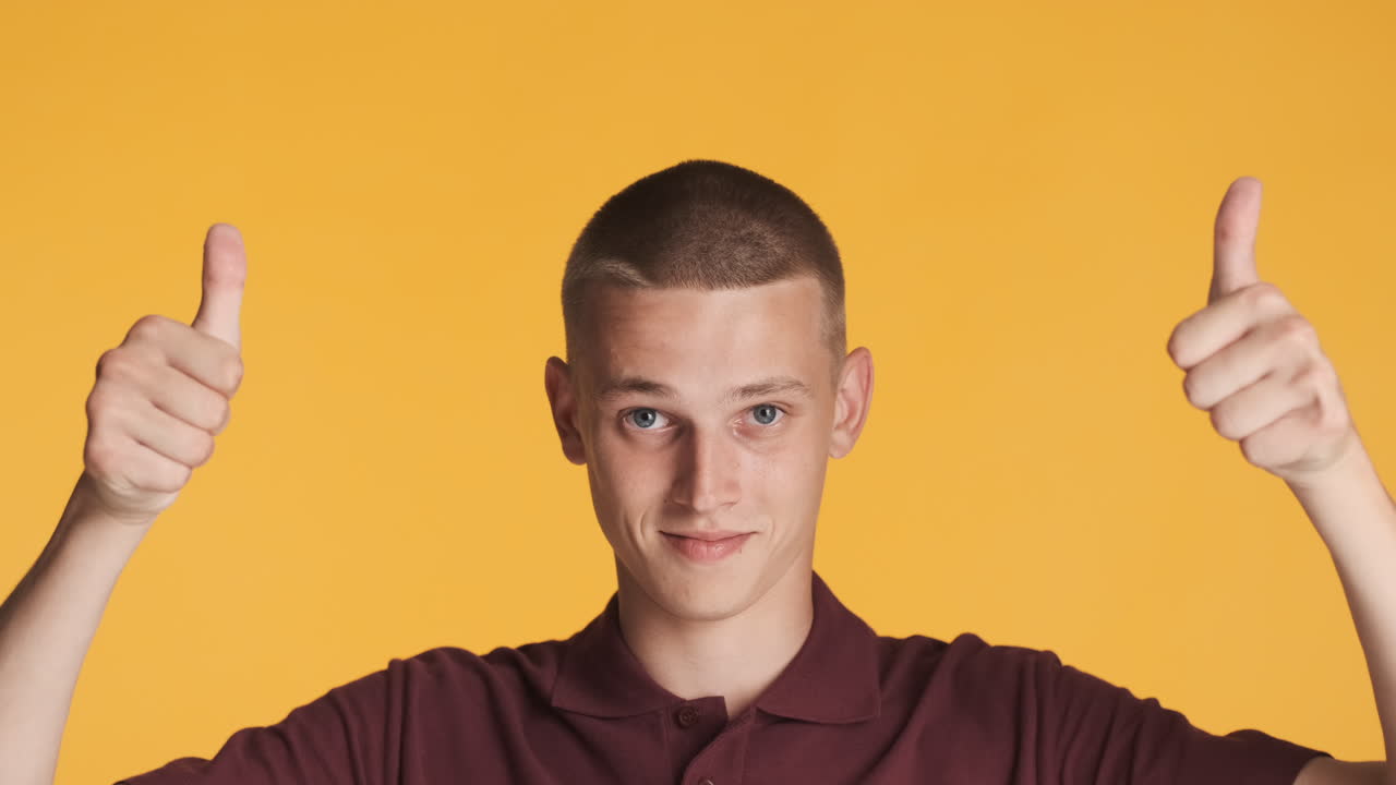 어린 소년은 손가락을 높이 가리키고 엄지손가락을 들고