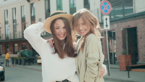 two happy friends posing outdoors