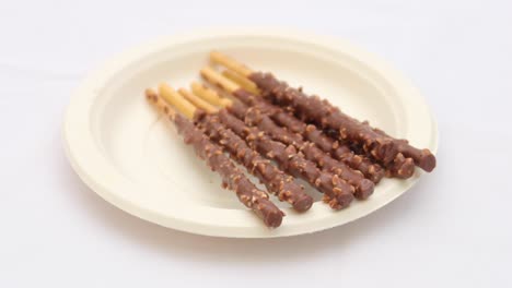 chocolate covered biscuit sticks on a plate