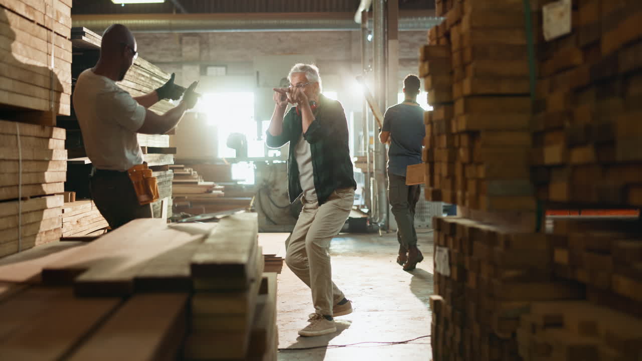 Men in a lumber warehouse high-fiving
