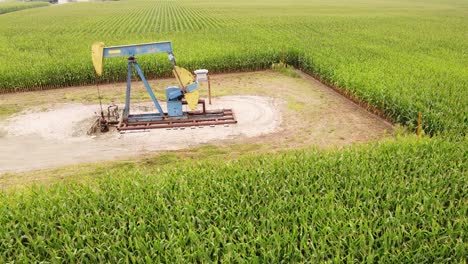 Oil-Well-In-A-Corn-Field-In-Mount-Pleasant,-Isabella-County,-Michigan---aerial-shot