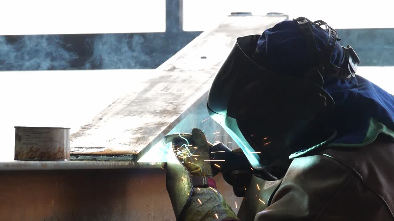 Sparks fly as skilled welder crafts metal in industrial surroundings